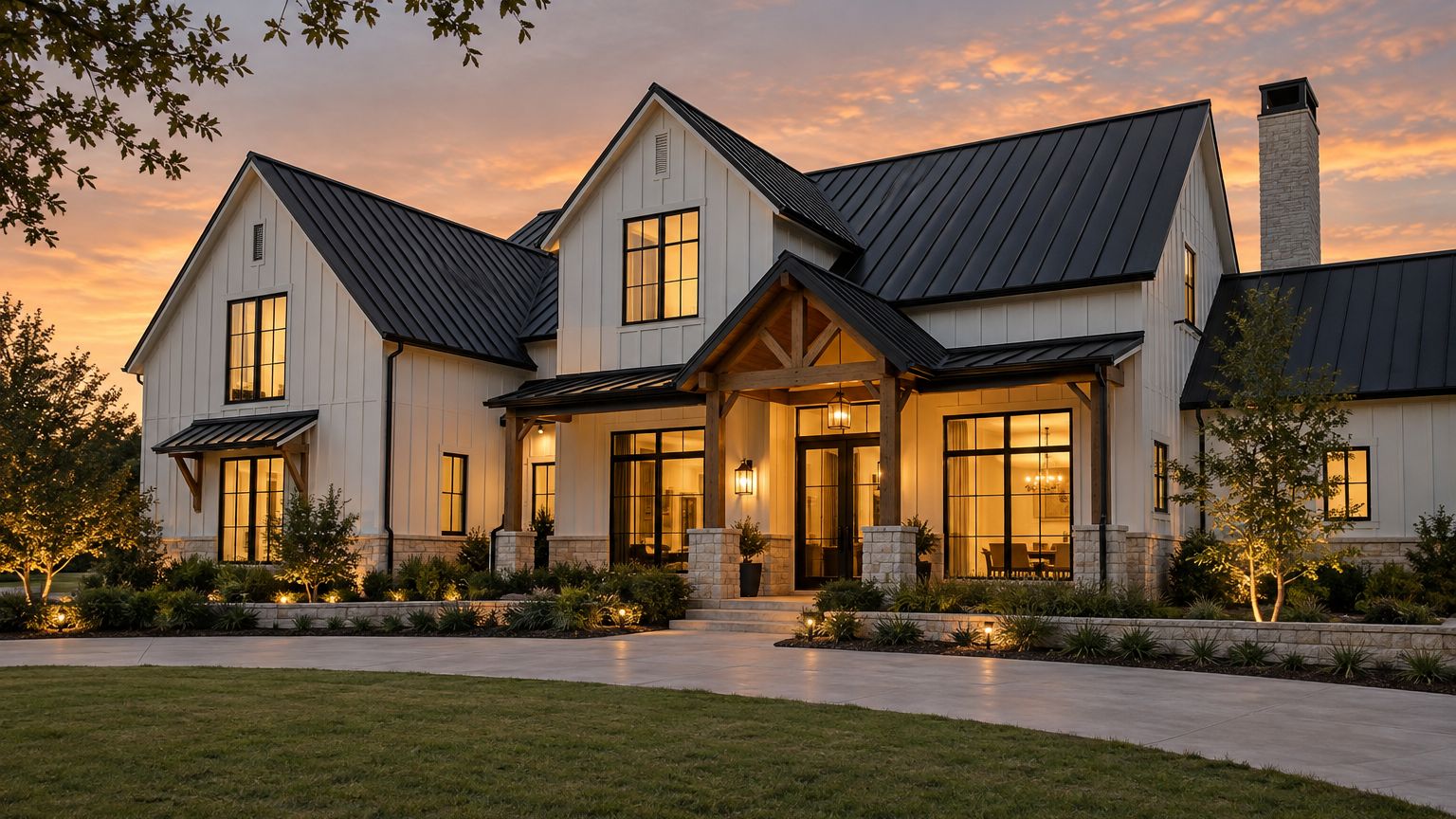 Modern farmhouse home with a black standing-seam metal roof at dusk