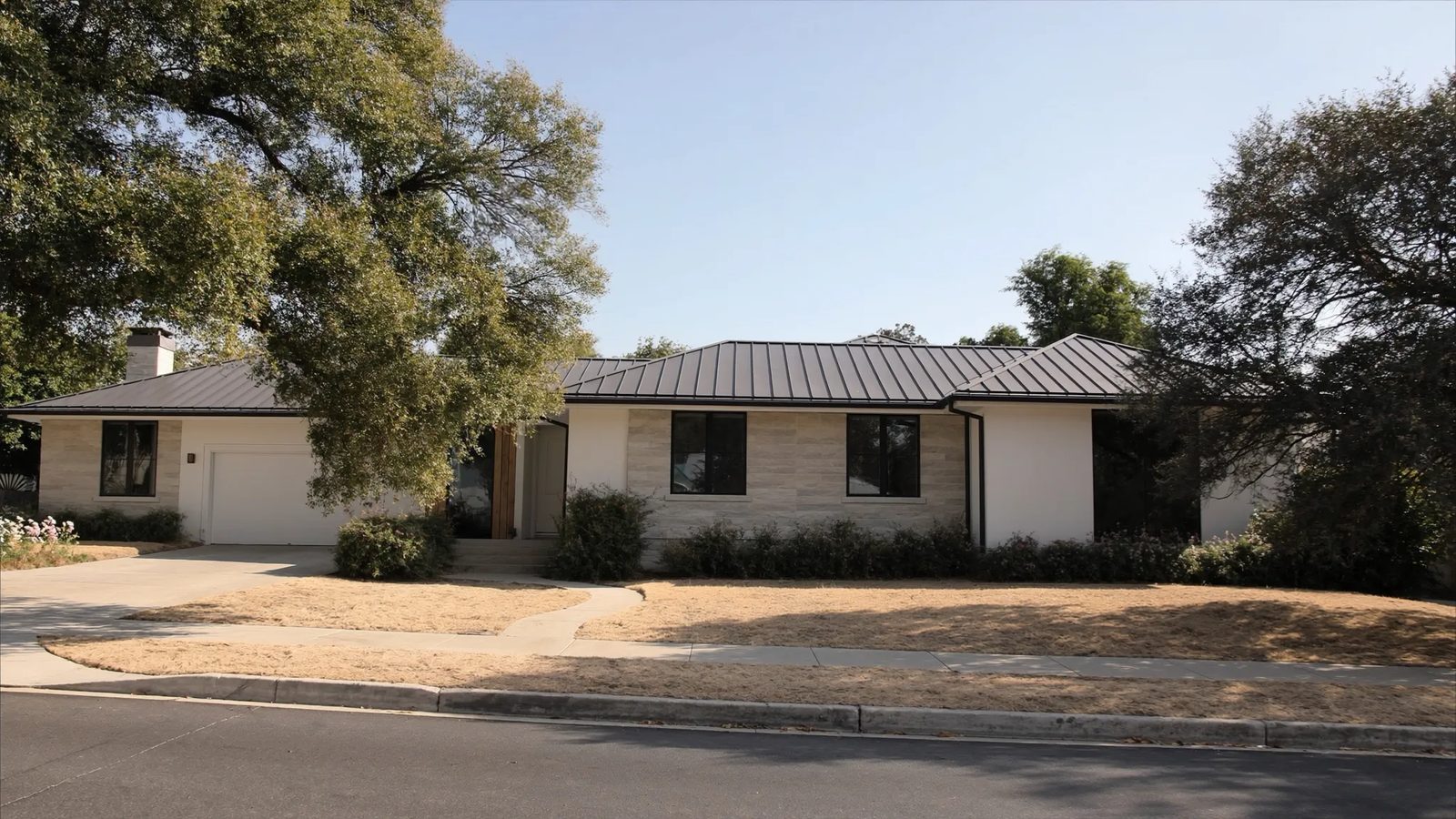 Modern Dallas home with a charcoal standing-seam metal roof